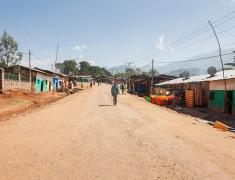 Ethiopia-People walking on dirt road by houses